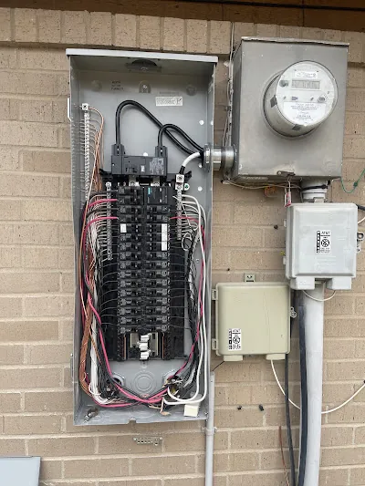 Electrical panel and utility meter on a brick wall
