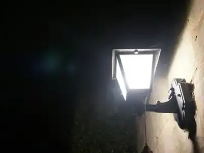 Security light lighting up a wall at night