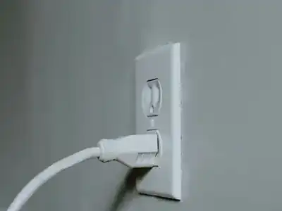 Charger cable plugged into a wall outlet