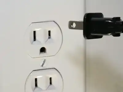 Lamp plug next to a wall outlet